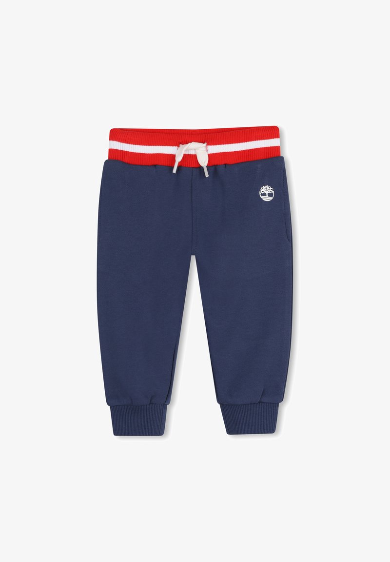 Pantalon de survêtement bleu marine pour tout-petit avec ceinture élastique rayée rouge et blanche, cordelette blanche, poignets côtelés, et petit logo d'arbre blanc à l'avant.