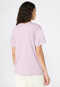 Light purple short-sleeve t-shirt with a relaxed fit, round neckline, and smooth cotton texture. Visible stitching along the hem and sleeves.