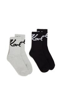 Par de calcetines cortos: uno gris y otro negro, ambos con textura acanalada y logotipo en blanco que contrasta.