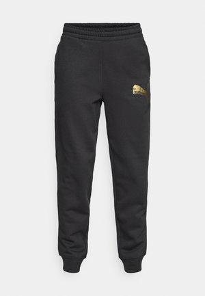 Pantalons de survêtement en coton noir avec taille élastique, chevilles côtelées et logo Puma doré sur la cuisse gauche. Design simple et décontracté.