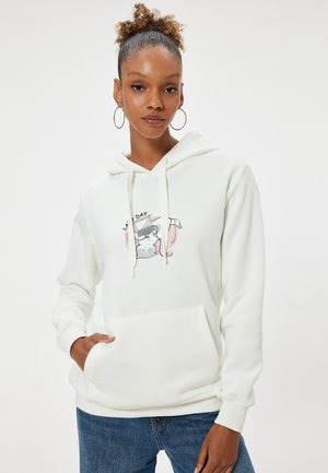 Hoodie en coton blanc avec une poche frontale, featuring un imprimé graphique d'un chat et d'un ordinateur portable. Manches longues, capuche avec cordon, texture douce.