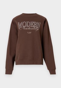 Sweatshirt marron avec un col rond, des manches longues et le texte "MODERN Neutrality" imprimé en blanc au dos. Texture de tissu douce.