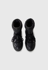 Black ankle boots with a quilted upper, round toe, lace-up front, and rubber soles. Features a padded cuff and logo detail on the side.