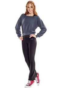 Gray long-sleeve top with a rounded neckline, paired with black fitted leggings and red sneakers. Sweatshirt features a logo detail.