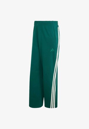 Pantalon de survêtement vert Adidas avec taille élastique et trois bandes blanches courant sur le côté extérieur de chaque jambe.