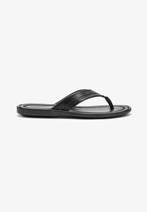 Black leather flip-flop with a thin strap, featuring a molded footbed and red accent stitching on the straps, smooth texture, minimalist design.
