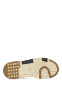 Shoe sole with a textured black rubber section, beige midsole, and brown rubber outsole featuring circular and linear patterns for grip.