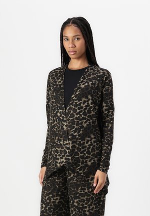 Black and tan animal print cardigan with long sleeves, relaxed fit, and a draped front design, paired with a black shirt underneath.