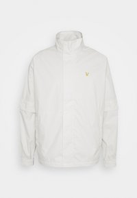 Biała bluza zapinana na zamek z odpinanymi krótkimi rękawami, wysokim kołnierzem, elastycznymi mankietami i małym żółtym logotypem orła po lewej stronie klatki piersiowej.