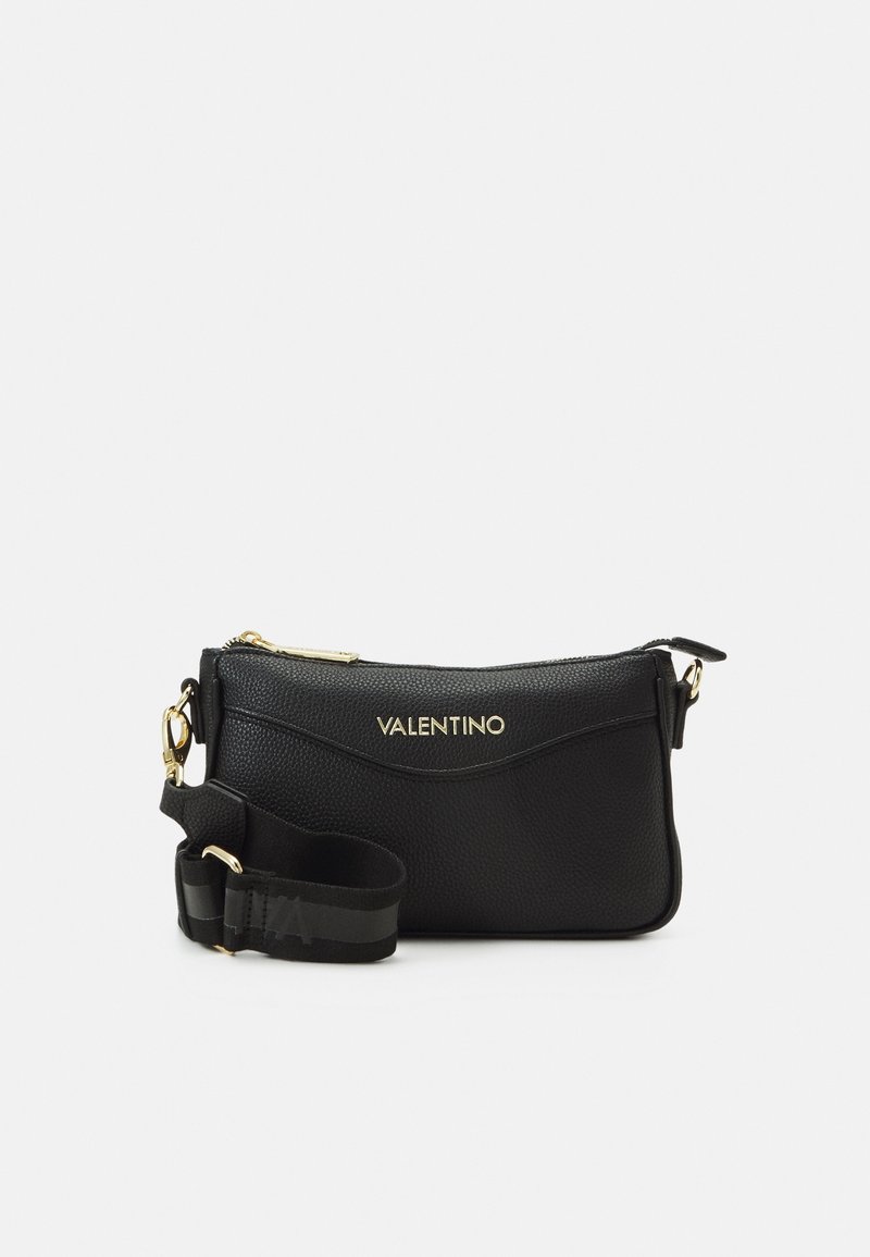 Black leather crossbody bag with textured finish, gold hardware, and a logo. Features an adjustable strap and zip closure.