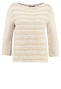 Maglione lavorato a maglia color crema con maniche a tre quarti. Presenta strisce orizzontali testurizzate e un design a vestibilità ampia. Tessuto morbido.