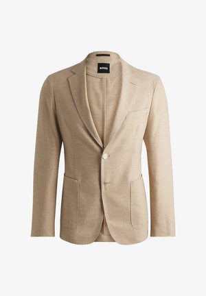 Blazer de lino beige con solapa notch, cierre de un botón, dos bolsillos frontales y diseño ajustado. Etiqueta de la marca visible en el interior.