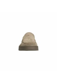 Beige suede slip-on shoes with a rounded toe, stitching accents, and a sturdy brown rubber sole. Smooth texture and minimalist design.