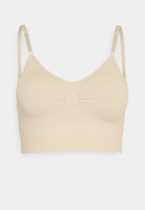 Beige bralette with adjustable straps, soft fabric, scoop neckline, gathered center, and a seamless band at the bottom for comfort.