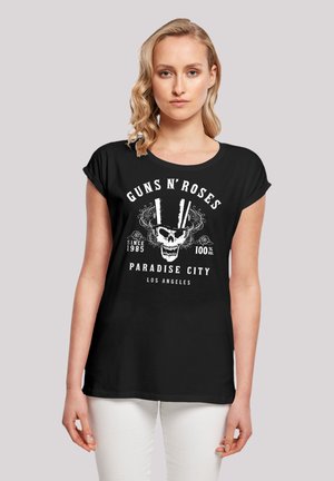 Black cotton t-shirt featuring a skull graphic with top hats, and text "GUNS N' ROSES PARADISE CITY LOS ANGELES" in white. Short sleeves.