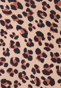 Leopard print fabric featuring black spots on a beige background, with scattered rust-colored accents. Smooth texture.