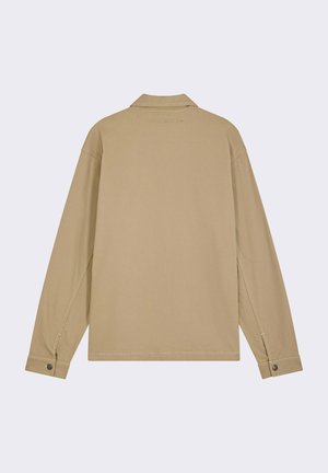 Beige longsleeve shirt met kraag, zichtbare stiksels en knoopmanchetten. Heeft een relaxte pasvorm en een logo detail op de achterkant. Glad materiaal.