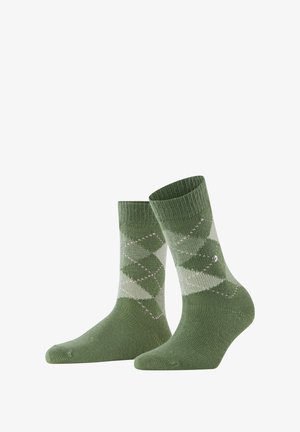 Green patterned socks featuring a diamond design in varying shades, ribbed cuff, and reinforced toe. Made from soft textile material.