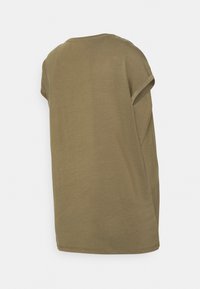 T-shirt de mangas curtas verde-oliva com decote redondo, corte descontraído e punhos de mangas dobrados. Tecido suave com uma textura lisa.