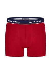 Rode katoenen boxershorts met een marineblauwe tailleband waarop "HAPPY SHORTS" in witte tekst staat, en een contrasterende streepdetail.