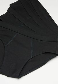 Schwarze hochtaillierte Unterw�äsche aus weichem Stoff mit Flatlock-Nähten und ohne sichtbare Etiketten, ausgestattet mit einem nahtlosen Design für optimalen Komfort.