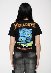 Black t-shirt featuring a colorful graphic of two blue barrels with radioactive symbols and a slime detail, text reading “MEGADETH CONTAMINATED.”