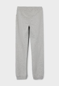 Graue Jogginghosen aus einem weichen Baumwollgemisch. Mit einem elastischen Bund und schmal zulaufenden Beinen, die an den Knöcheln mit Rippstrickbündchen versehen sind.