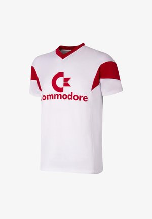 White jersey with red accents, featuring a V-neck and short sleeves. Displays a large red "Commodore" logo on the front. Made from soft fabric.