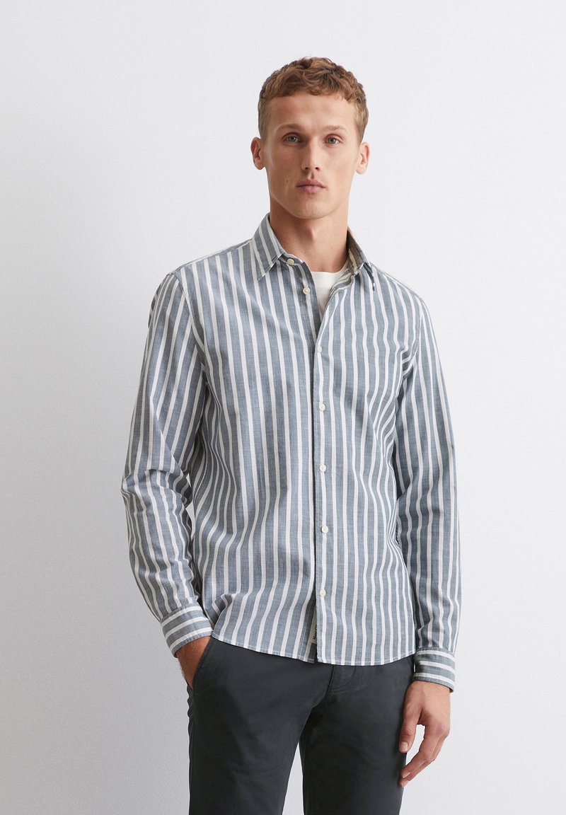 Striped button-up shirt in light blue and white cotton, featuring long sleeves, a collar, and a relaxed fit. Accented with a slim design.