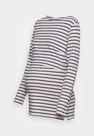 Maternity striped long-sleeve top in cream with navy horizontal stripes, features a relaxed fit and a front panel for accommodating a growing belly.