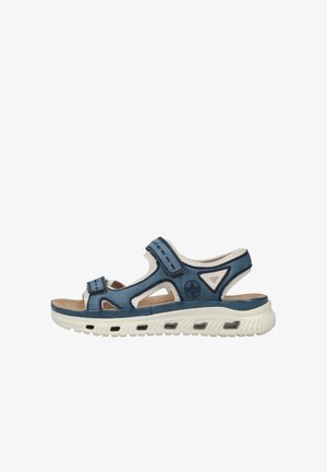Blaue synthetische Sandale mit einer weißen strukturierten Sohle, ausgestattet mit verstellbaren Riemen und ausgestanztem Design. Enthält ein Logo an der Seite und eine Polsterung.
