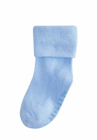 Calza a maglia azzurro chiaro con risvolto, caratterizzata da una texture a coste e punta liscia. Realizzata in tessuto morbido per il massimo comfort.