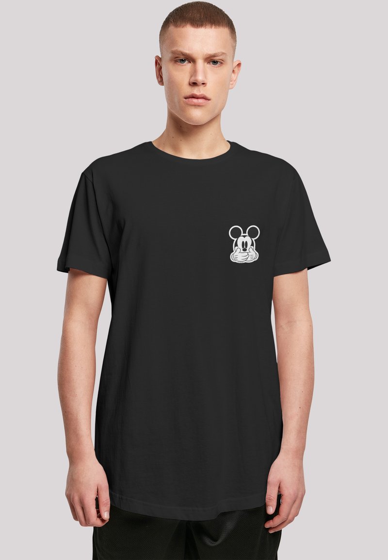 Svart t-skjorte laget av bomull, med et hvitt Mickey Mouse-motiv på venstre bryst. Korte ermer og avslappet passform.