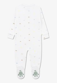 Λευκό φορμάκι με μακριά μανίκια με πολύχρωμα λογότυπα Lacoste. Διαθέτει ριμπ μανσέτες και υφασμάτινα σχέδια χελωνών σε πράσινο στα πατουσάκια.