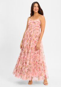 Maxi dress in sheer pink fabric, featuring floral patterns, spaghetti straps, and a ruched bodice. Layered with a flowing skirt.