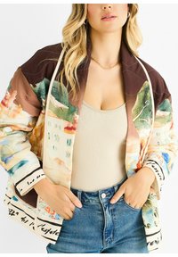Quilted bomber jacket with a colorful watercolor design, featuring a brown collar and cuffs, and black text accents along the hem.