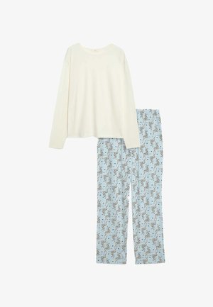 Maglia a maniche lunghe color crema chiaro abbinata a pantaloni da pigiama azzurri con stampa integrale a zebra, realizzati in tessuto morbido e traspirante.