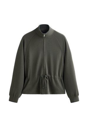 Mørkegrøn zip-jakke med høj krave, ribbet tekstur og snor i taljen. Har lange ærmer og raglan-skulderdesign.