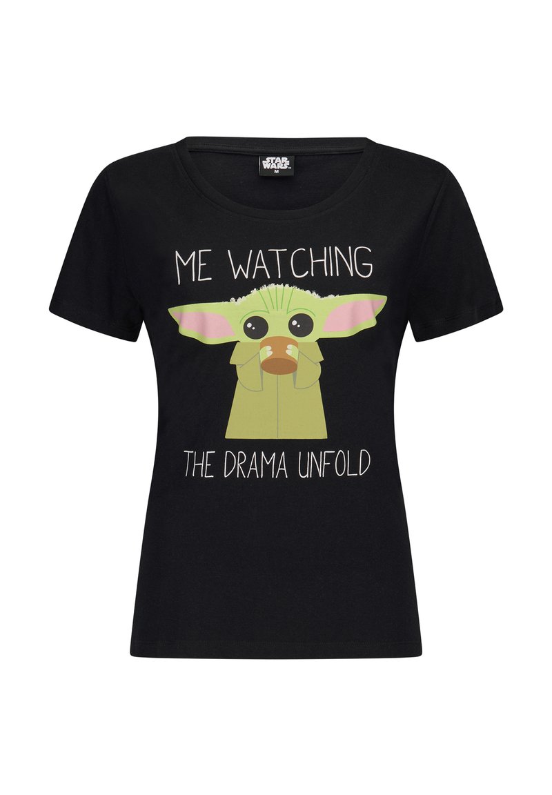 Black cotton t-shirt with short sleeves, round neckline, featuring a cartoon character with green skin and pink ears, and text that reads "ME WATCHING THE DRAMA UNFOLD."