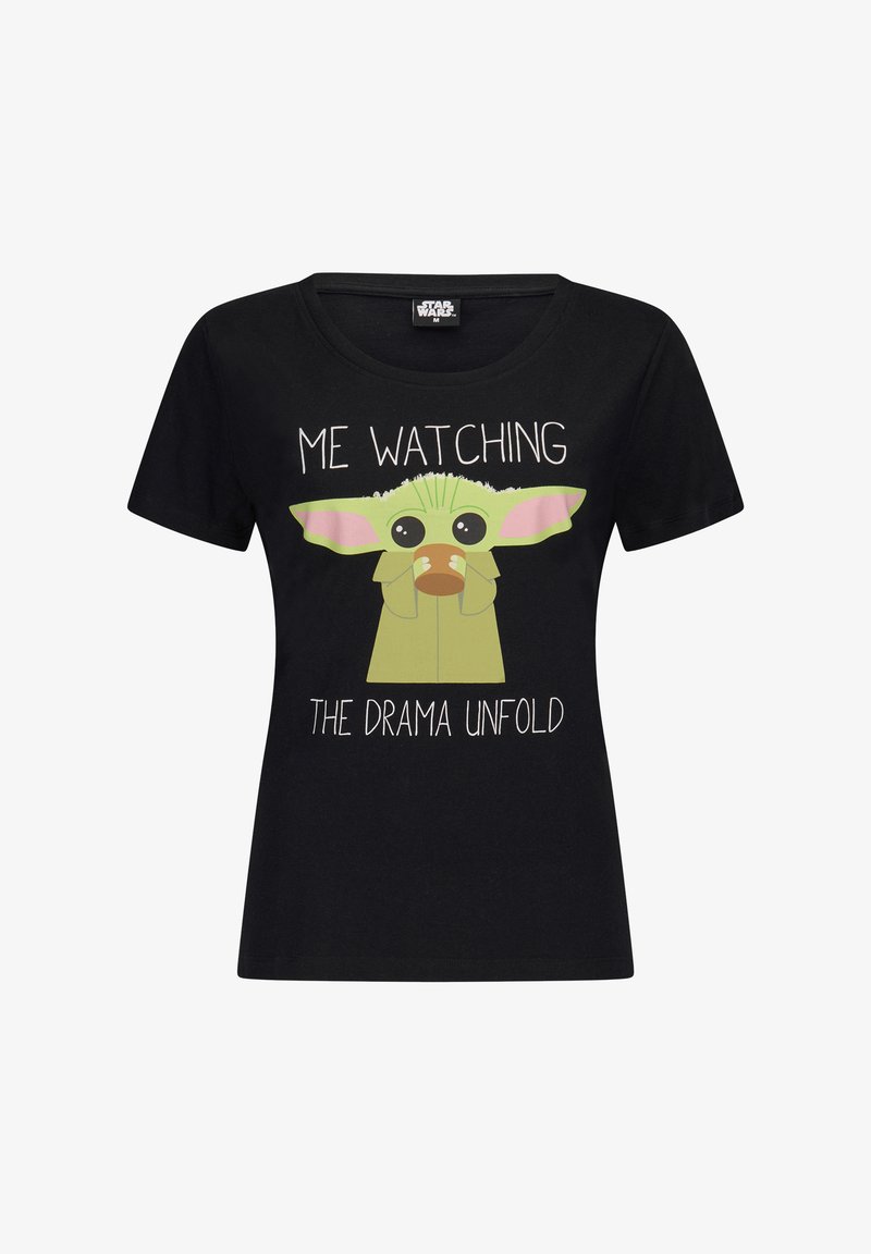 Black cotton t-shirt with short sleeves, round neckline, featuring a cartoon character with green skin and pink ears, and text that reads "ME WATCHING THE DRAMA UNFOLD."