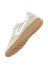 Beige glitter sneakers with white accents, textured rubber outsole, rounded toe, and lace-up front. Logo visible on the side and tongue.