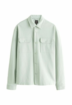 Veste en tissu doux de couleur vert menthe clair, dotée d'un col pointu, d'une fermeture à boutons sur le devant et de deux poches poitrine.