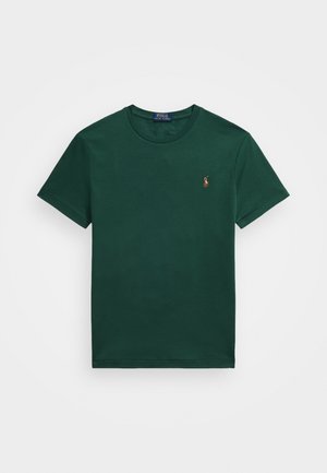 T-shirt à col rond à manches courtes, vert foncé, avec un petit logo de joueur de Polo brodé sur la poitrine gauche.
