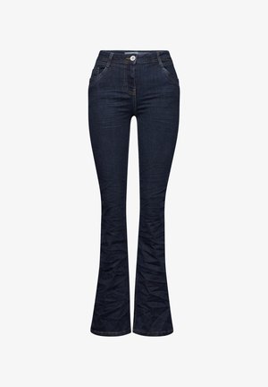 Tummansinisiä farkkuja, joissa on levenevät lahkeet, muotoiltu vyötärö, etutaskut ja teksturoitu pinta. Varustettu napitus ja erottuva ompelu.