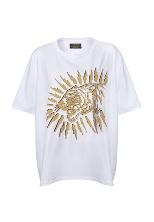 White oversized T-shirt featuring a gold tiger graphic print with sunburst accents. Made from soft cotton material.