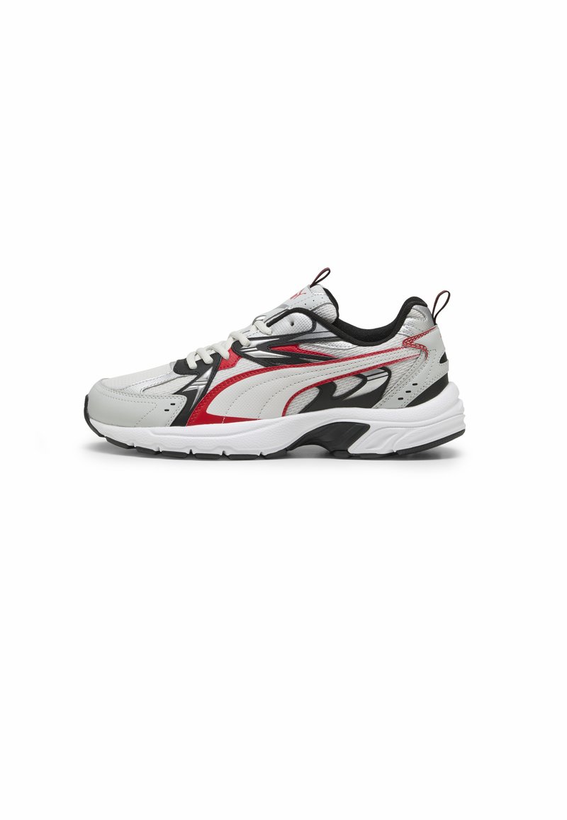 White athletic sneaker with red and black accents, featuring a textured upper, cushioned sole, and a lace-up closure with a pull tab.