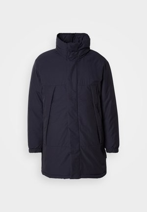 Marineblaue gepolsterte Jacke mit hohem Kragen, Fronttaschen und elastischen Bündchen. Glattes Material mit minimalistischem Design und ohne sichtbare Verschlüsse.