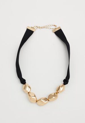 Collier en tissu noir avec cinq grosses perles en or irrégulières et fermoir réglable en or, sur fond blanc.