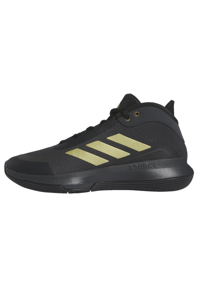 Scarpe da ginnastica nere con una tomaia testurizzata e tre strisce metalliche dorate. Caratterizzate da una suola in gomma e un colletto imbottito per il supporto.