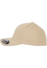Beige színű baseball sapka, strukturált koronával, ívelt szélekkel és szellőző lyukakkal. A szélén méretmatrica található. Pamut anyag.